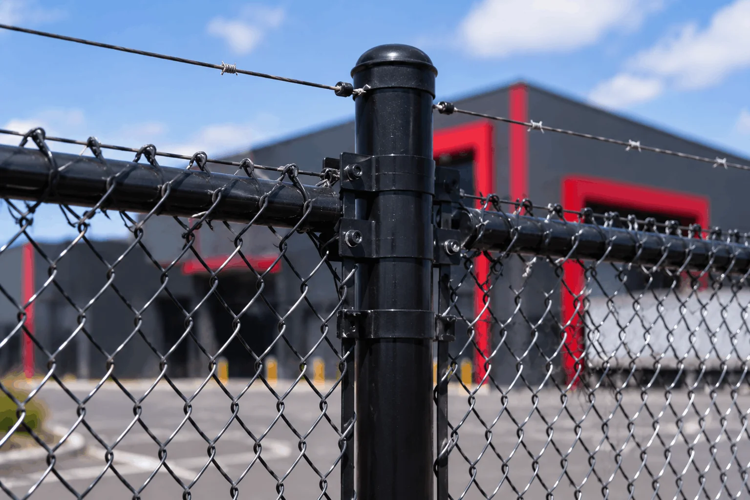 Line wire fencing installed above chain link mesh fencing system.